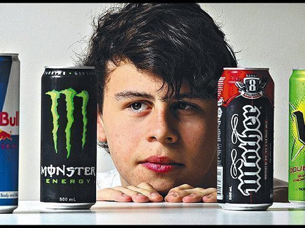 A kid looking at energy drinks