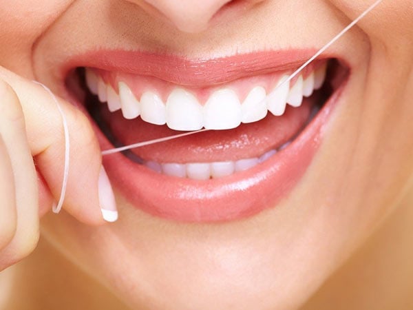 A woman flossing
