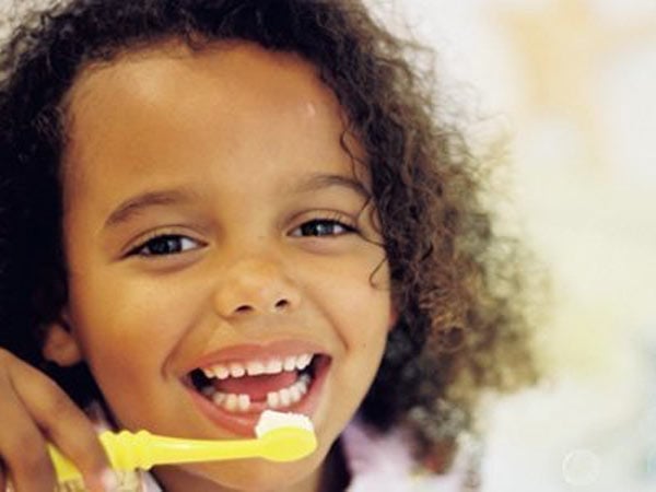 A kid brushing their teeth