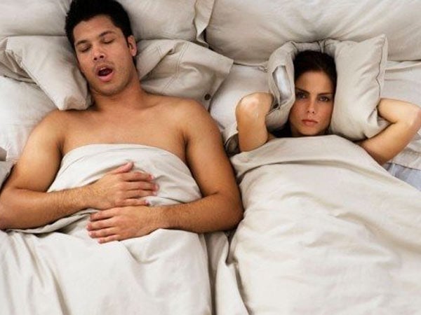 Man snoring, woman annoyed