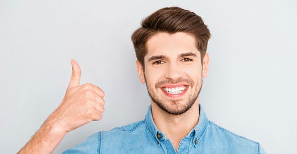 Man giving a thumbs up and smiling