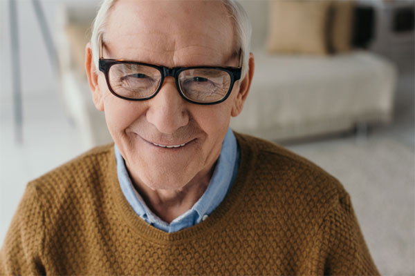 Older man in glasses smiling