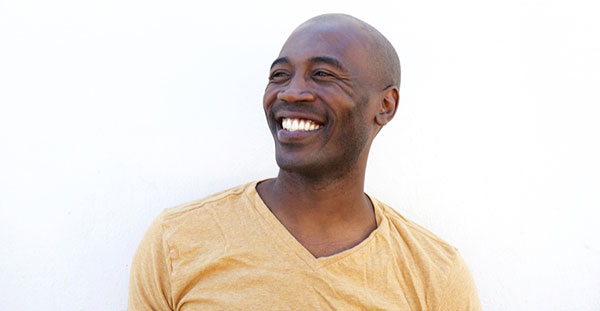 Man smiling, looking away