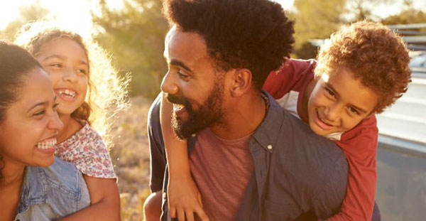 Couple with kids, smiling and laughing