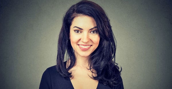 Woman smiling, on dark background