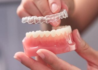 Showing how Invisalign fits (using a dental prosthetic)