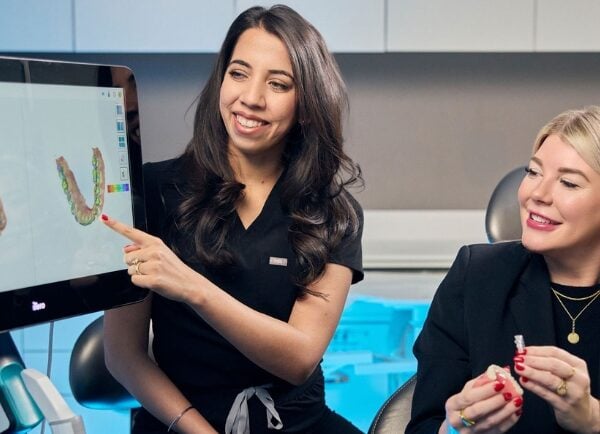 Staff Member Explaining Teeth Model to Patient