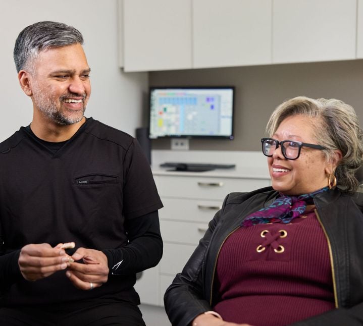 Dr. Muhammad consulting a patient on dental treatment options
