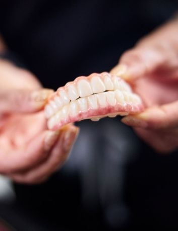 Doctor Holding Implant Model