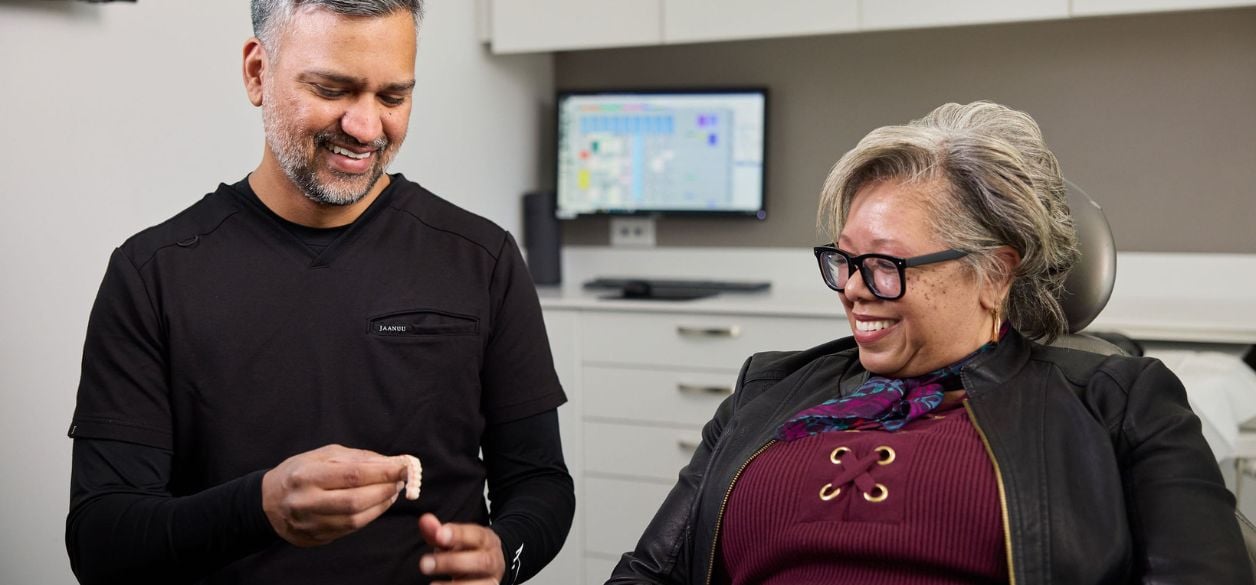 Dr. Muhammad discussing dental implant options with patient at CascadesONE