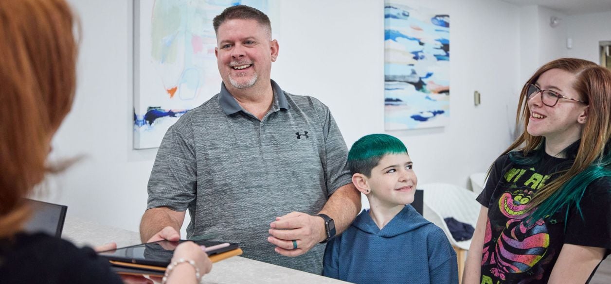 A family checking in for their dental appointment at CascadesONE Dental