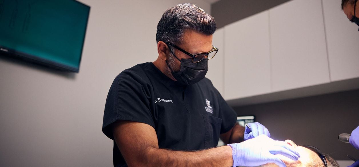 CascadesONE dentist Dr. Ruparelia performing periodontal therapy services on a patient