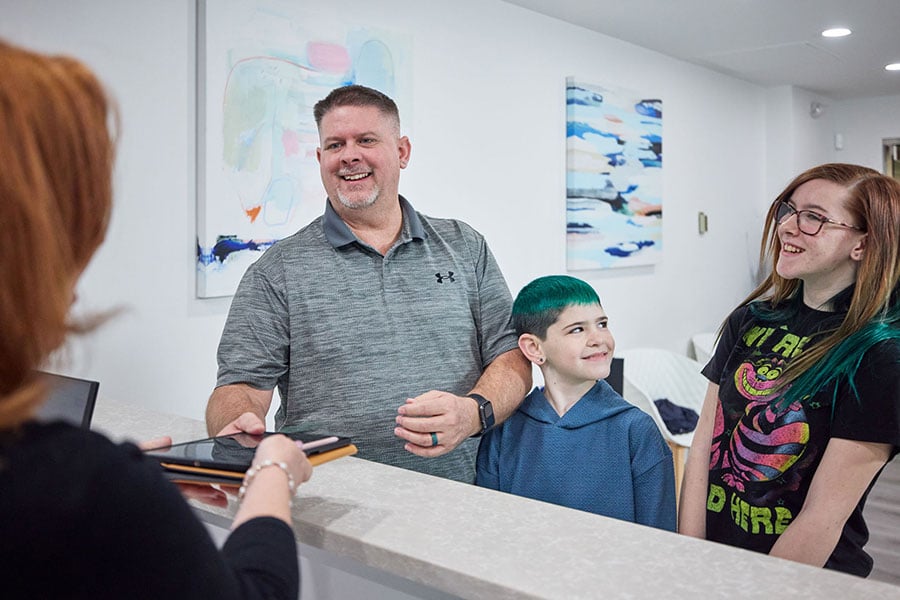 Family Checking into CascadesONE Dental in the Main Lobby