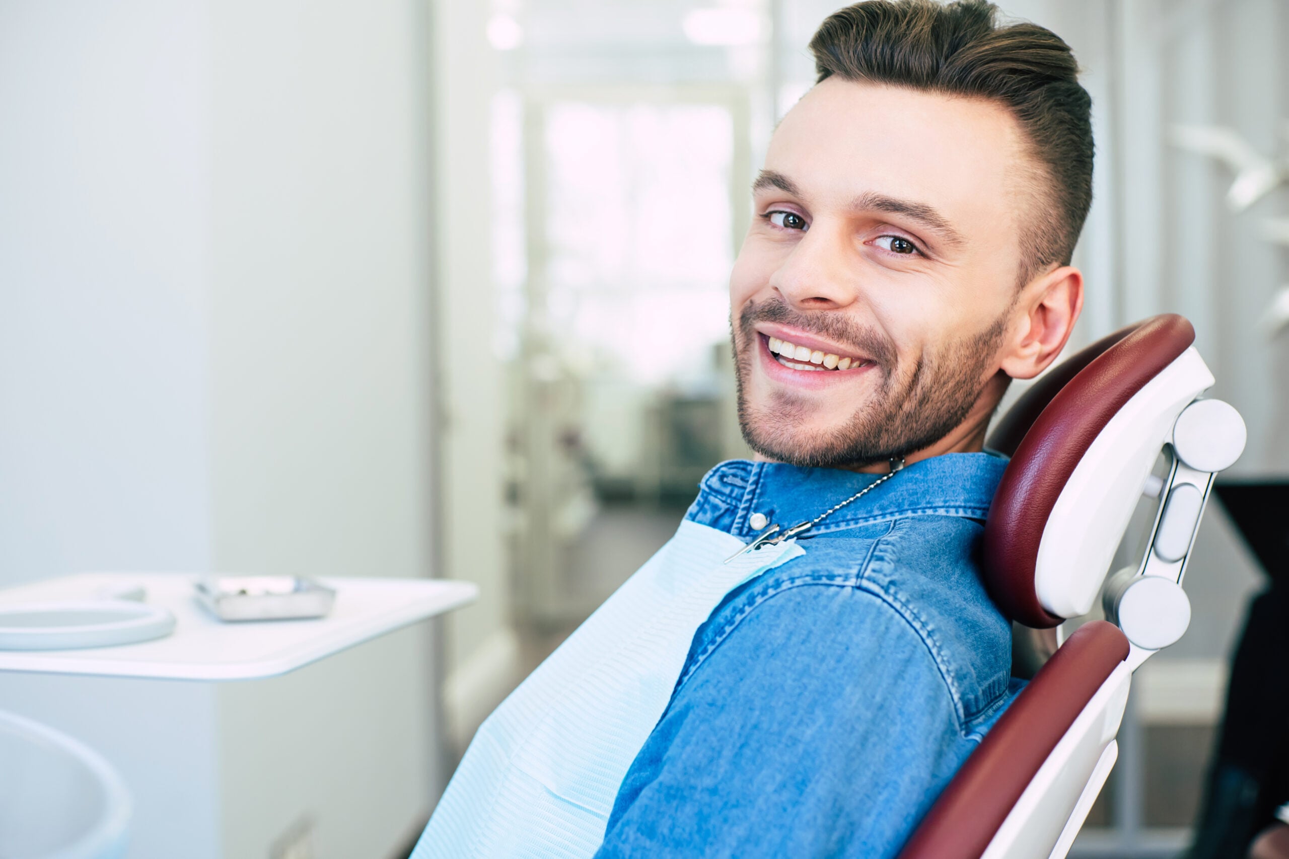 Happy man in dental chair
